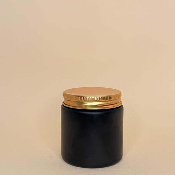 Envase de vidrio negro con tapa dorada 100ML