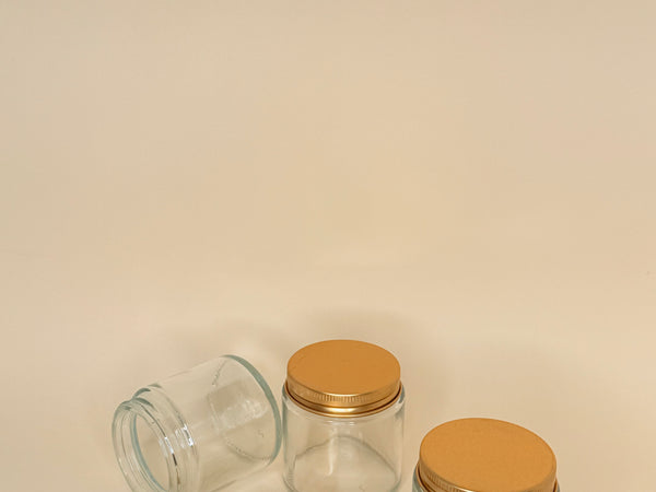 Envase de vidrio transparente C/tapa dorada 100 ML