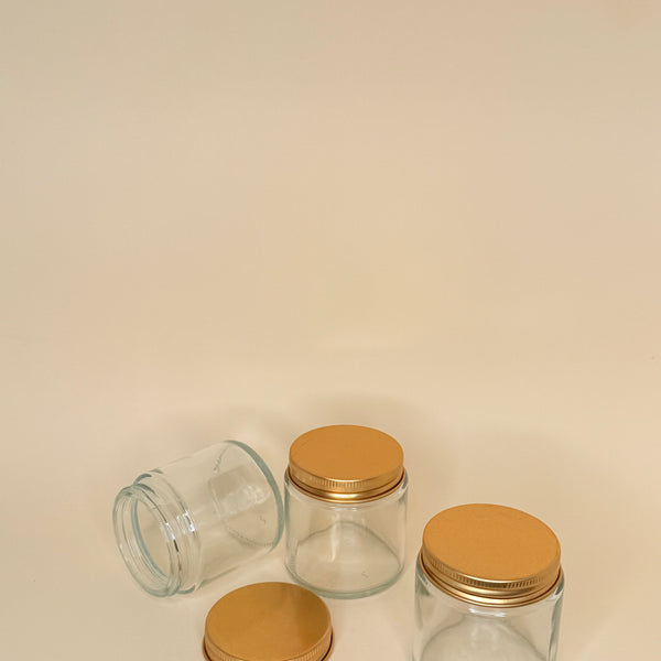 Envase de vidrio transparente C/tapa dorada 100 ML