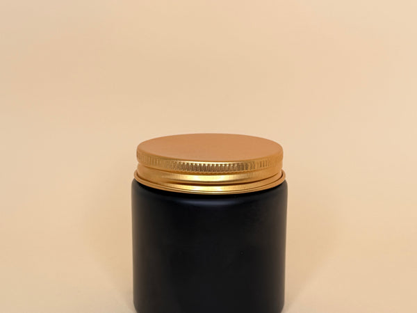Envase de vidrio negro con tapa dorada 100ML