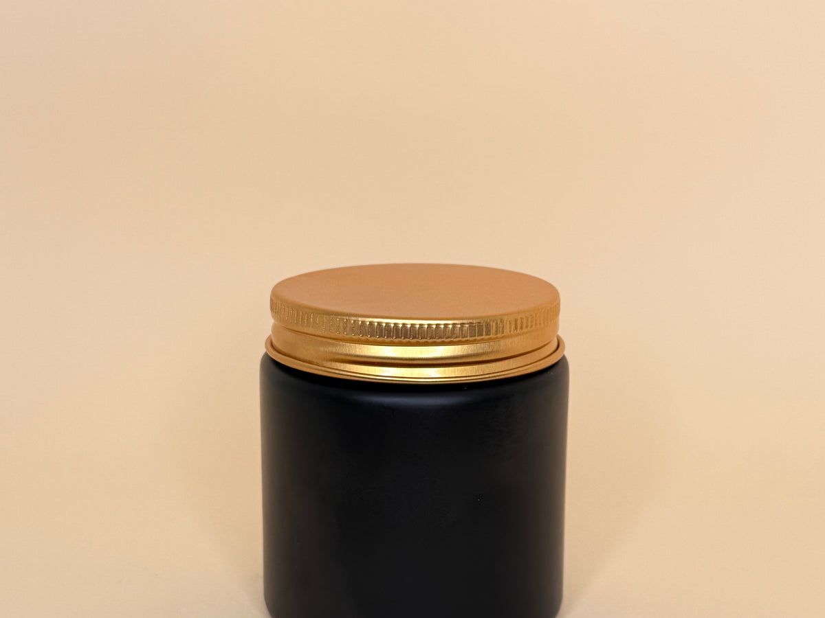 Envase de vidrio negro con tapa dorada 100ML